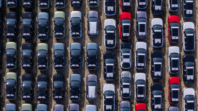 Aerial view of rows of new cars parked in a large outdoor lot in Gdansk, Poland.