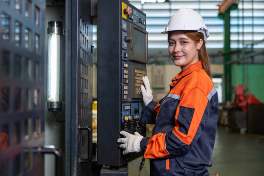 Portrait Engineer Woman Works Operate CNC Machine in Factory Working Hours in Safety Gear Looking camera Happy Smiling