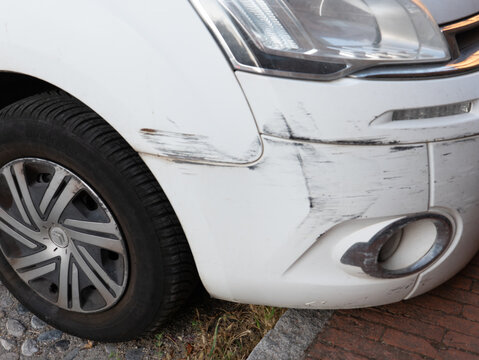 Citroen C4 white car bumper damage, fender scratches, accident repair, insurance claim, collision detail