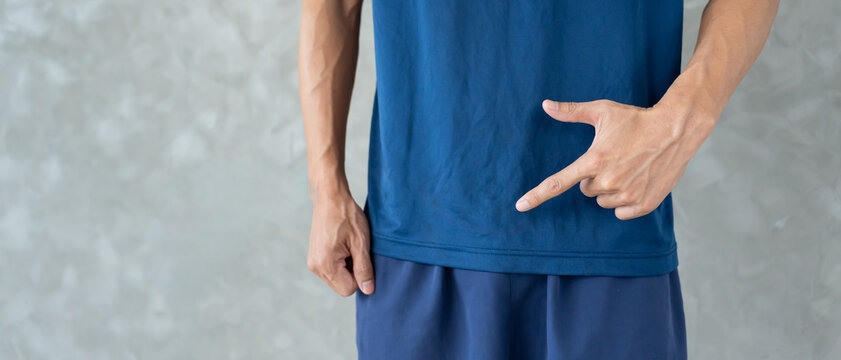 Man hold hand in front of private parts feeling discomfort from disease and inflammation. Venereal, testicular cancer. bladder problems, erectile dysfunction, premature ejaculation, prostate cancer