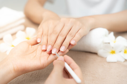 Woman receive care service by professional Beautician Manicure at spa centre. Nail beauty salon use nail file for Glazing treatment. manicurist make nail customer to beautiful. body care spa treatment