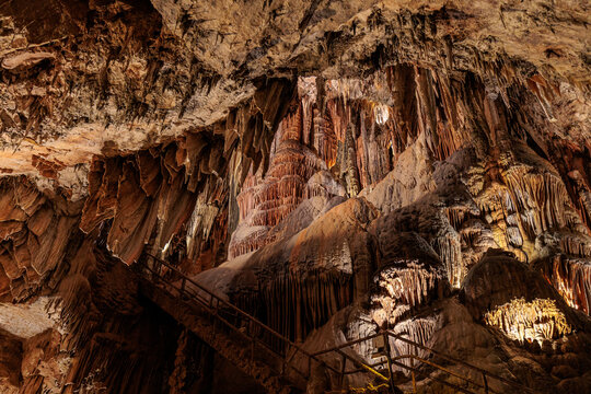 Stalactites and stalagmites next to some stairs inside the Valporquero Cave, Vegacervera, Le&oacute;n, Spain.