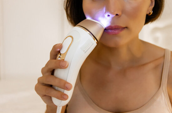 Macro Shot of Female Applying Precision IPL Epilator Head to Upper Lip Area for Effective Facial Hair Removal