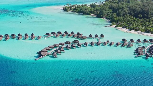 Bora Bora, French Polynesia. Drone Shot of Luxury Bungalows of Hotel Resort Above Turquoise Lagoon Water