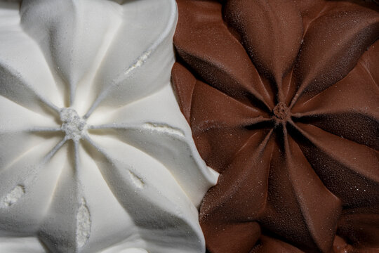 Chocolate and vanilla ice cream closeup. Macro texture of chocolate and vanilla star shaped ice cream swirls background