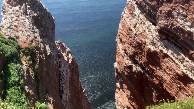 View into narrow cliff gorge descending toward the sea