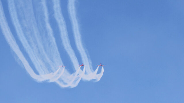 Aerobatic Display Team Flying in Formation with White Smoke Trails