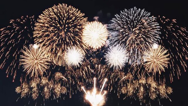 Golden Fireworks exploding in a dark night sky with sparkling trails during celebration events