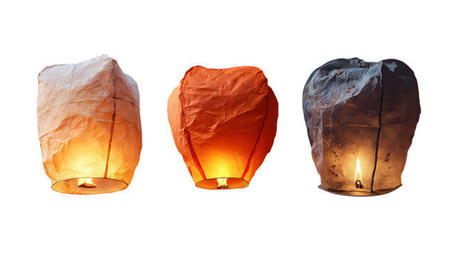 Three glowing paper sky lanterns isolated on transparent background