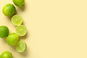 Fototapeta premium Fresh ripe limes on yellow background