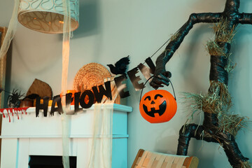 Obraz premium Interior of festive living room with Spooky Halloween monster, garland and autumn decorations on fireplace