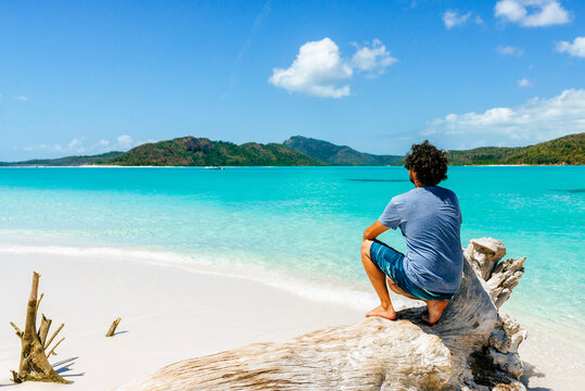 Man relaxing on Whitehaven Beach in Whitsunday Islands, Australia