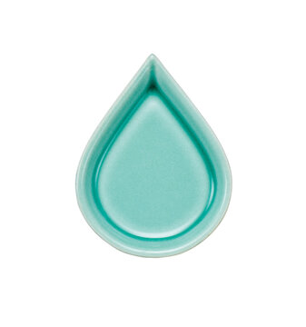 Green teardrop shaped ceramic small dish on white background