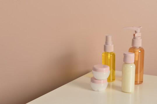 Travel cosmetic kit on table against color background