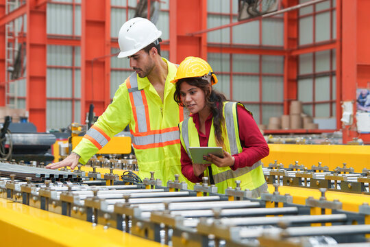 Collaboration between Male and Female Workers in Industrial Equipment Examination for Manufacturing Safety and Teamwork Solutions