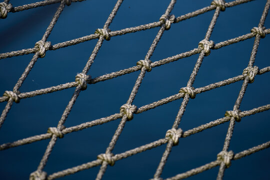 Close-up of safety netting on vessel with blue water background, Gdynia, Pomerania, Poland, Baltic Sea, Europe