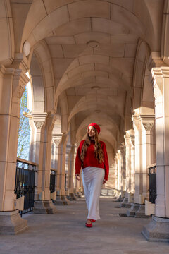 Fashion Beret Woman walking arcade due photoshoot on sunny day.