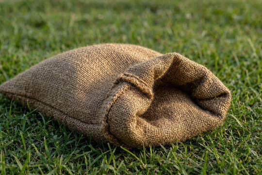 Sack race burlap bag on green grass. Traditional Indonesian Independence Day game prop.