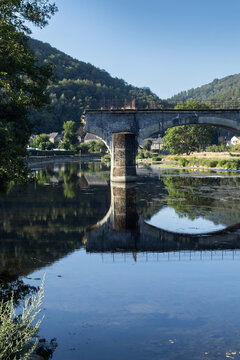The broken bridge at Bohan-sur-Semois, Le Pont Casse, in the Namur Province of Belgium. Captured on a sunny summer morning with blue sky, great reflections, copy space above and below.