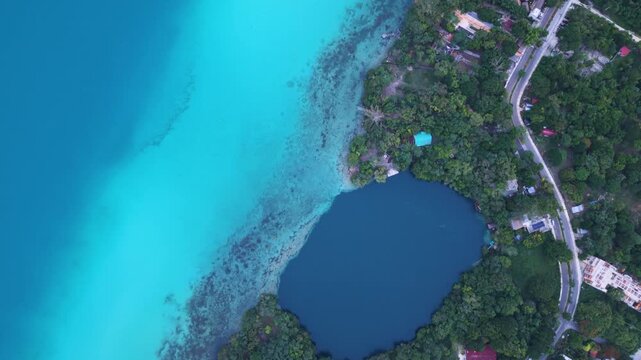 High-resolution drone footage of Bacalar Lagoon highlighting cenotes and vivid blue waters