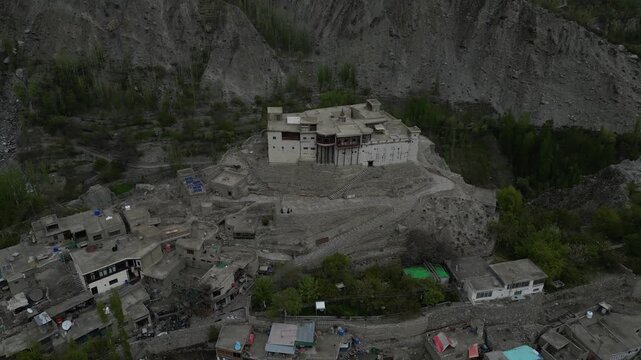 Low Altitude Drone Flight Over Historic Baltit Fortress in Karimabad Hunza Valley Pakistan with Traditional Stone Architecture and Mountain Views
