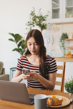 Asian woman using computer remote for business studying, watching online virtual webinar training meeting, video call. asian business woman talking on laptop in home office. Banner, copy space