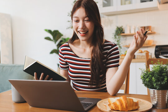 Asian woman using computer remote for business studying, watching online virtual webinar training meeting, video call. asian business woman talking on laptop in home office. Banner, copy space