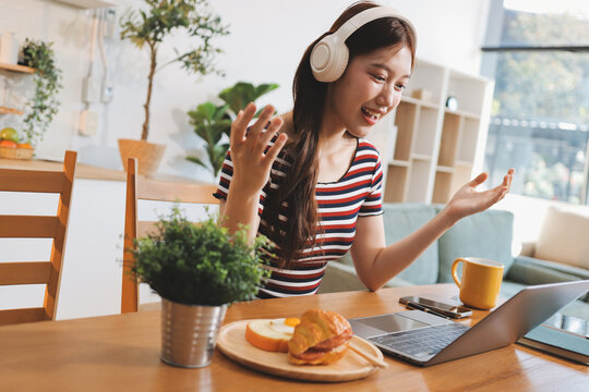 Asian woman using computer remote for business studying, watching online virtual webinar training meeting, video call. asian business woman talking on laptop in home office. Banner, copy space