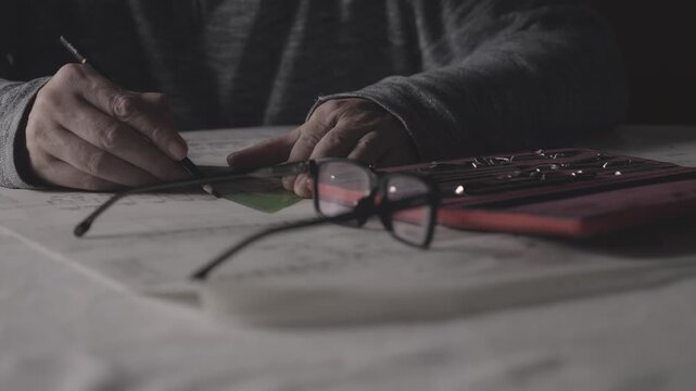 Engineer carefully measures and refines a technical blueprint with professional drafting tools in a low-lit studio, emphasizing precision, innovation, and the engineering design process.