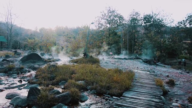 wooden bridge in to muang rae hot spring. boiling river water source in pai thailand
