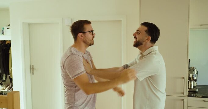 Two men push each other during a heated confrontation, escalating a verbal argument into a physical conflict. Concept of aggression, interpersonal conflict, and violence.