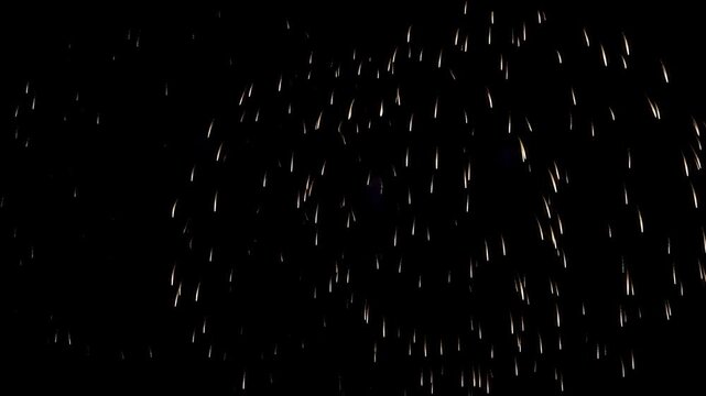 Golden firework burst in night sky with celebration sparkle and black sky display