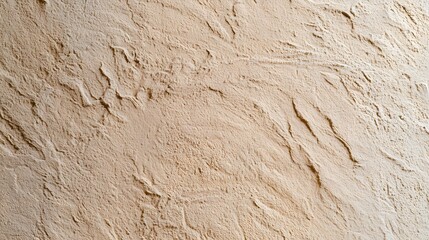 Naklejka premium Close up of textured beige plaster wall surface showing natural uneven strokes and subtle color variations