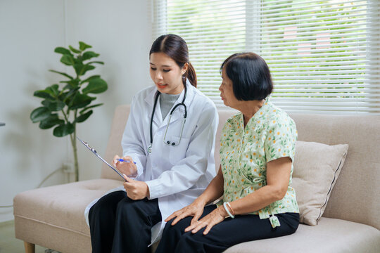 Doctor consulting senior patient during home health visit