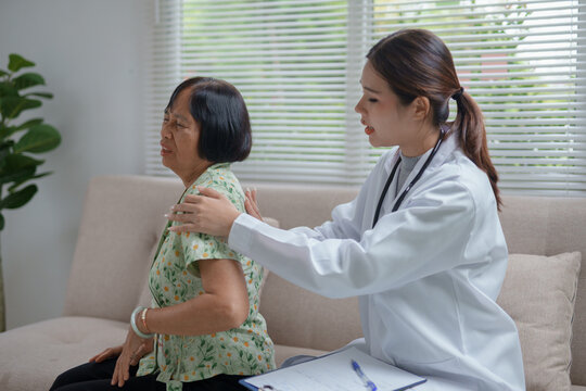 Doctor checking back pain of senior patient