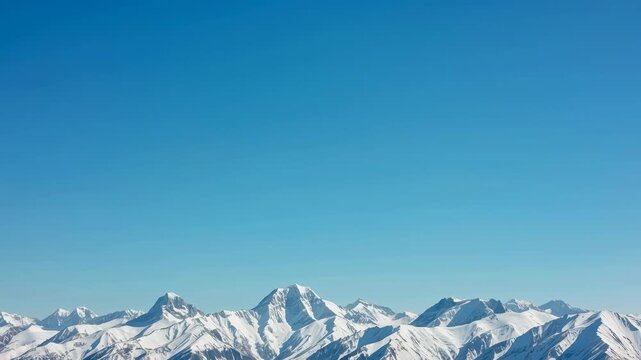 Snow mountain range under clear blue sky, serene winter alpine peak horizon