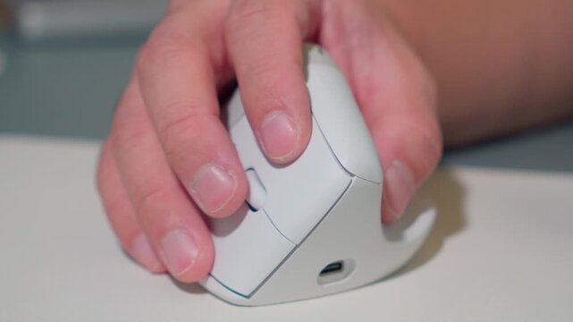 Close Up Man Hand Using Ergonomic Wireless Mouse at Office Desk