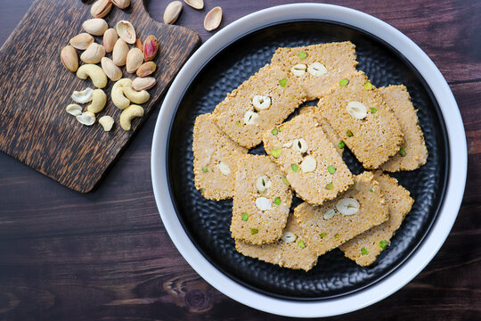 Til gajak, a traditional Indian winter sweet made with sesame seeds, jaggery, ghee, and dry fruits. Crunchy til chikki, a festive treat for Makar Sankranti. Tilgul. Sesame candy. Copy Space. Winter fo