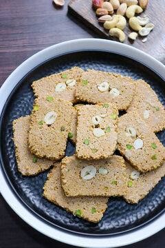 Til gajak, a traditional Indian winter sweet made with sesame seeds, jaggery, ghee, and dry fruits. Crunchy til chikki, a festive treat for Makar Sankranti. Tilgul. Sesame candy. Copy Space. Winter fo