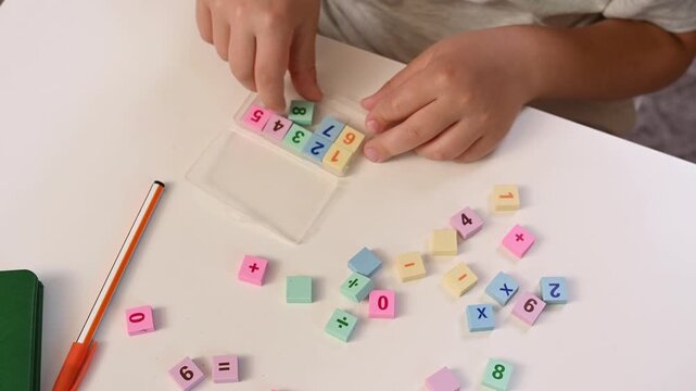 Hands close-up of Boy play with Colorful Math Blocks at Home, Early Childhood Education, STEM Learning, Homeschooling, Cognitive Development, Learning Through Play mathematics and counting top view
