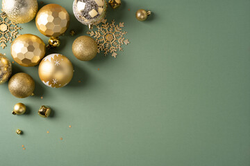 Fototapeta premium Gold Christmas ornaments and snowflake decorations on green background for New Year greeting