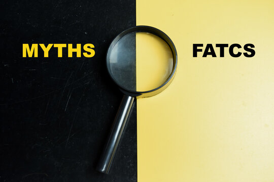 Concept of myths or facts write on color background with magnifying glass.