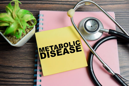 Concept of metabolic disease write on sticky notes with stethoscope isolated on Wooden Table.