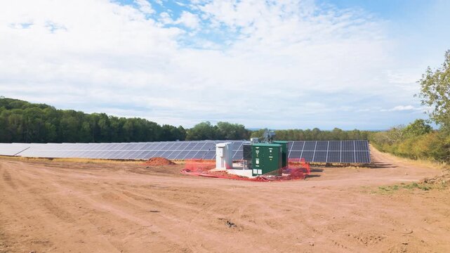Solar farm inverter and transformer substation station on an almost complete large scale solar farm