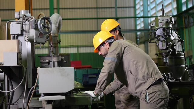 Industrial worker operating milling machine in manufacturing factory, Machinist working on heavy machinery in industrial plant, Technician team operating industrial equipment in production facility