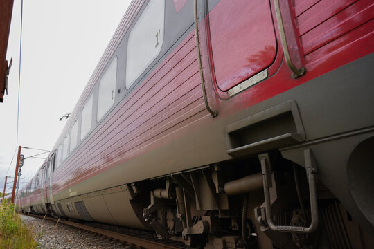 Close Up Low Angle View of Red Danish Passenger Train on Tracks