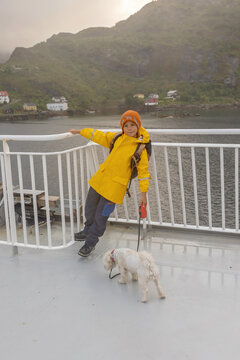 People, enjoying ferry ride between Bodo and Lofoten Moskenesoya summertime, child and adults on a ferry on sunset