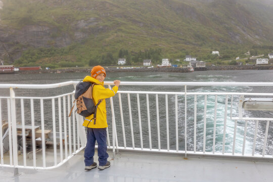 People, enjoying ferry ride between Bodo and Lofoten Moskenesoya summertime, child and adults on a ferry on sunset