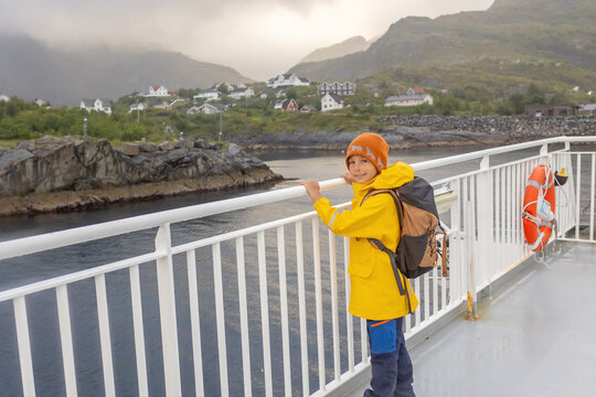 People, enjoying ferry ride between Bodo and Lofoten Moskenesoya summertime, child and adults on a ferry on sunset