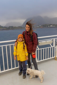 People, enjoying ferry ride between Bodo and Lofoten Moskenesoya summertime, child and adults on a ferry on sunset